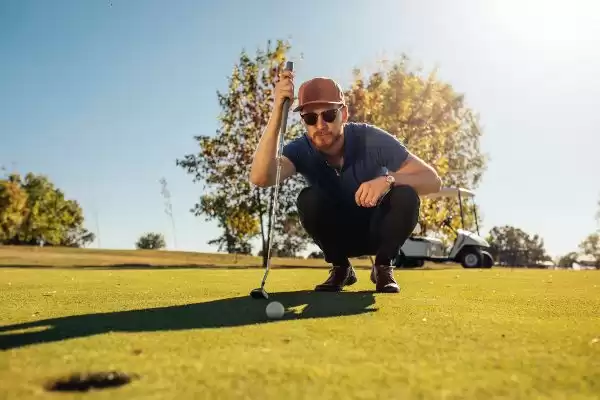 A player with his colored golf lenses focusing on the ball A player with his colored golf lenses focusing on the ball