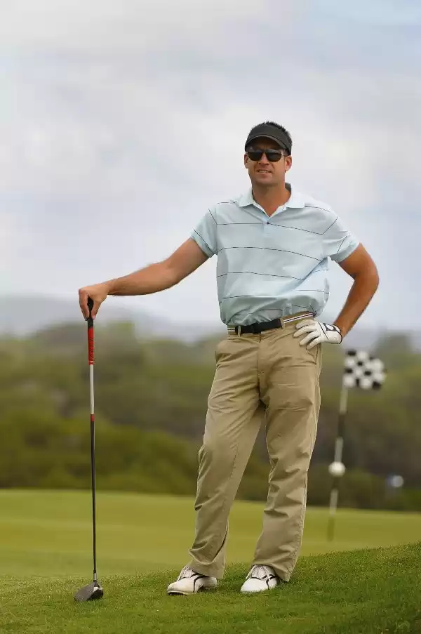 Player waiting to putt wearing golf sunglasses Player waiting to putt wearing golf sunglasses