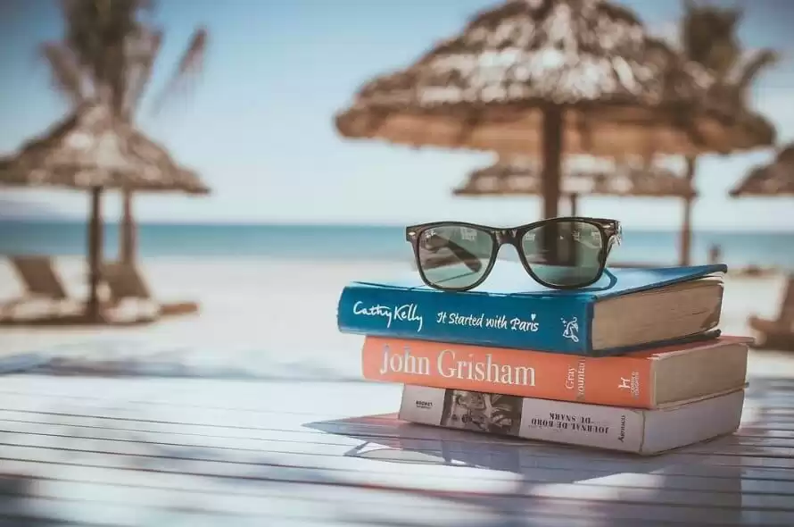 Sunglasses on top of the books Sunglasses on top of the books
