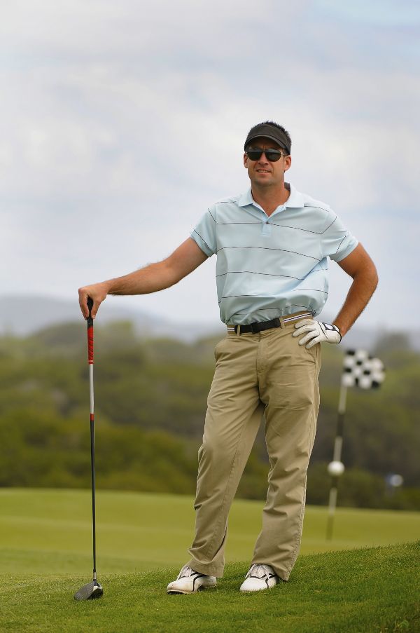 Player waiting to putt wearing golf sunglasses