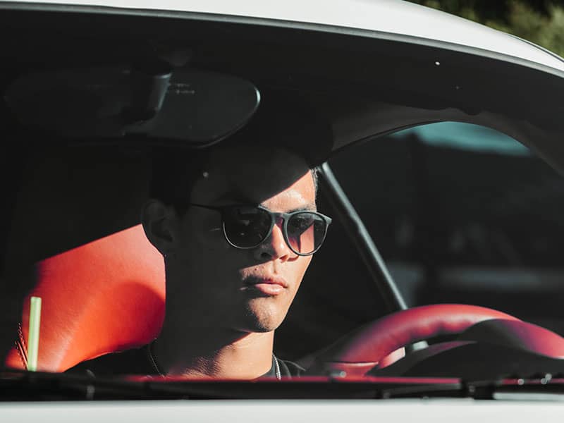 man driving in the sun and wearing sunglasses