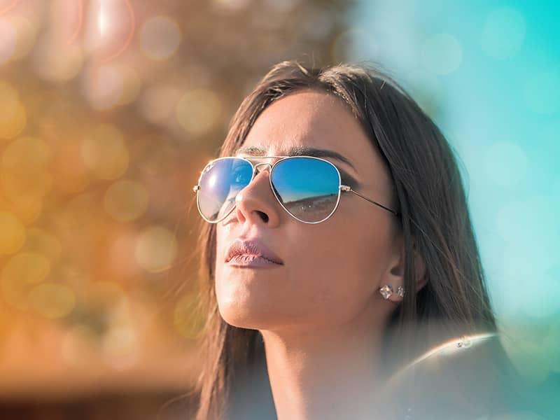 young lady wearing unisex aviator sunglasses