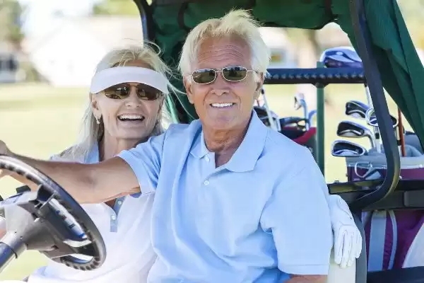 Couple wearing golf sunglasses