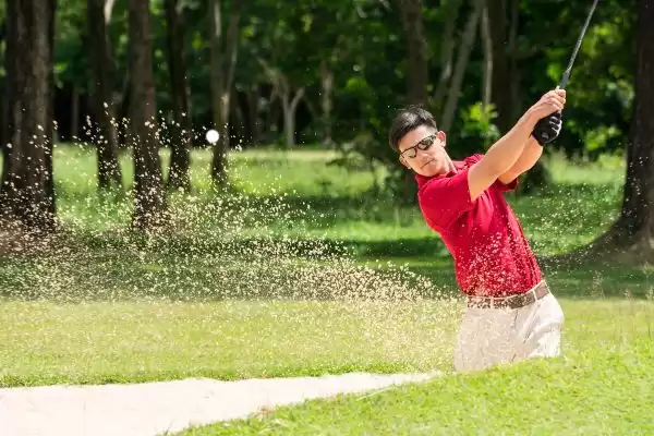 Man golfing with sunglasses
