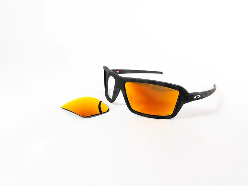 A pair of Oakley sunglasses showcasing orange lenses, perfect for hiking