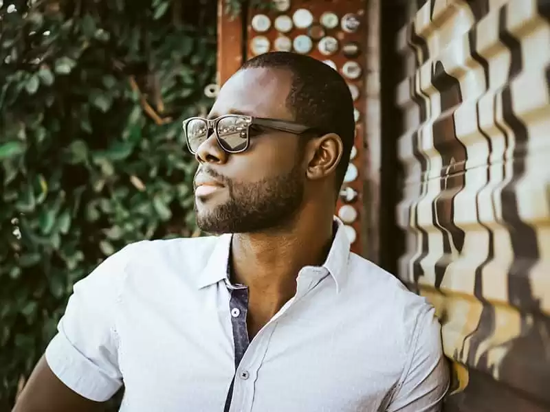 Dark skin man wearing unisex Wayfarer sunglasses