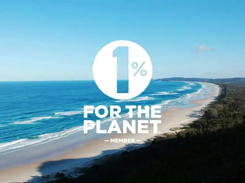 Coastal landscape with “1% for the Planet” logo representing environmental commitment and sustainability initiatives.