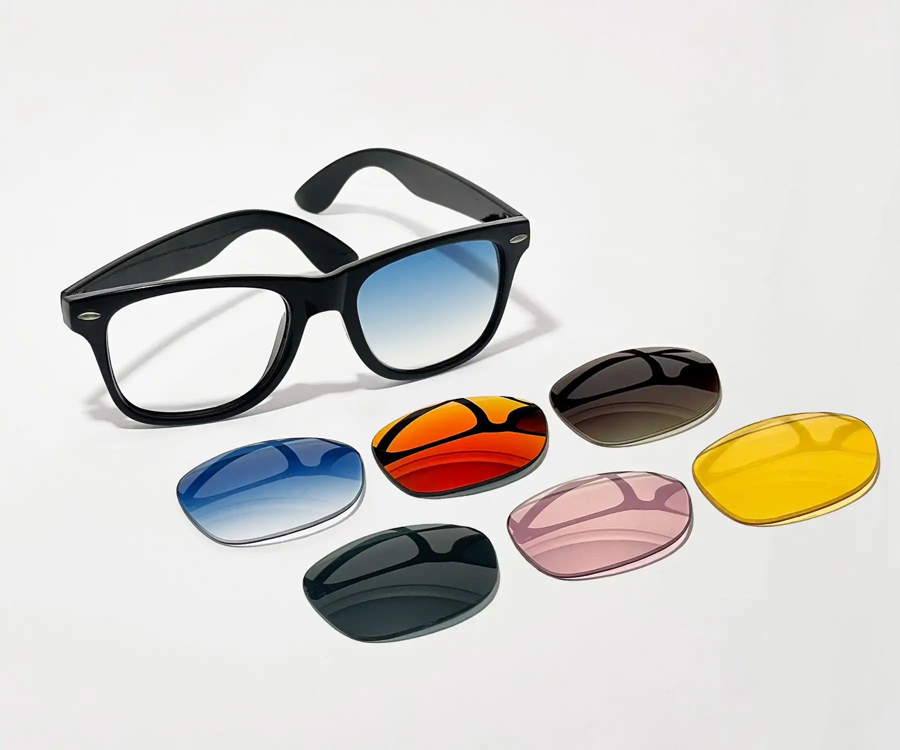 Wayfarer sunglass frames with one lens installed and several lens color options layed out