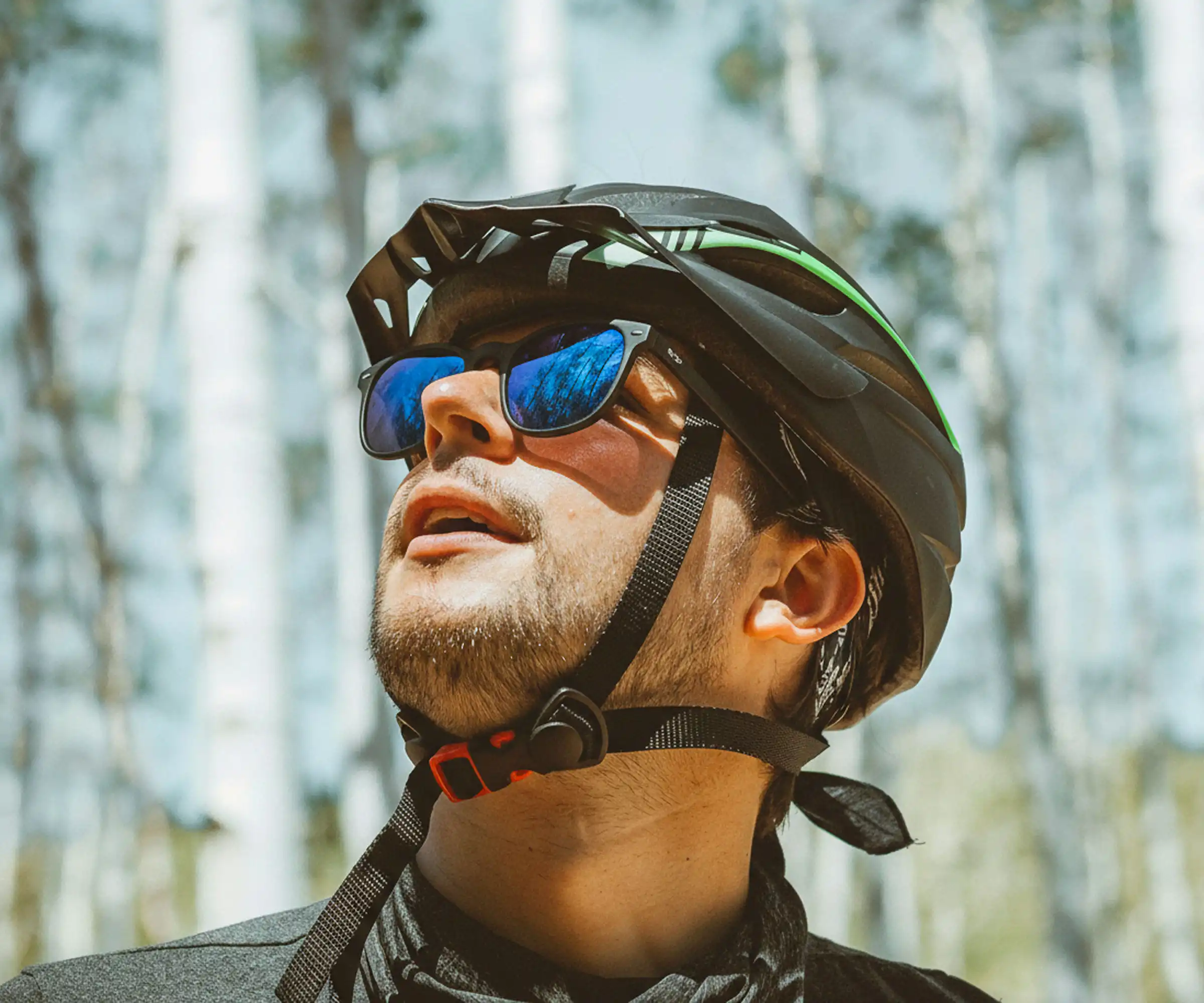A person wearing sunglasses outdoors for sports and lifestyle activities